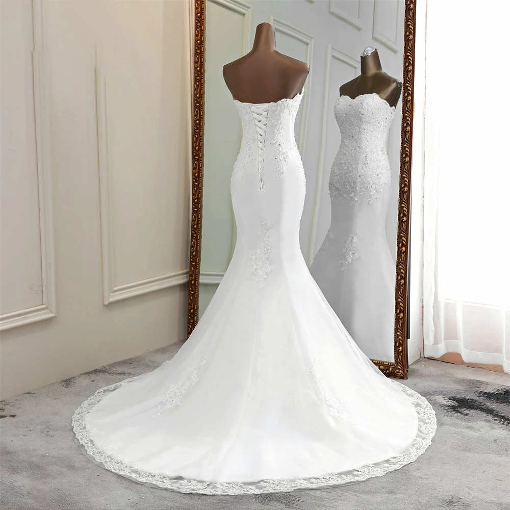 Full-body rear view of a strapless mermaid wedding dress with a corset back and elegant train, shown on a mannequin.