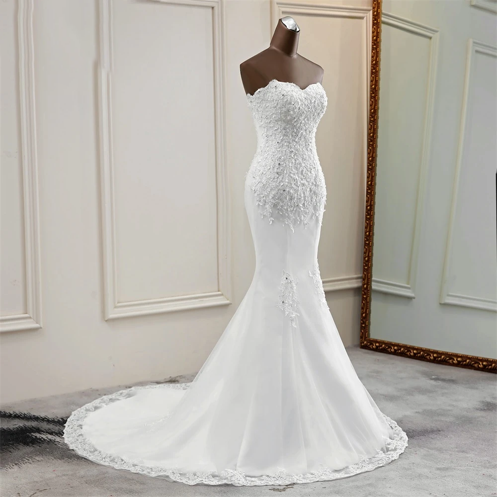 Side profile view of a stunning strapless mermaid wedding dress with a fitted beaded bodice.