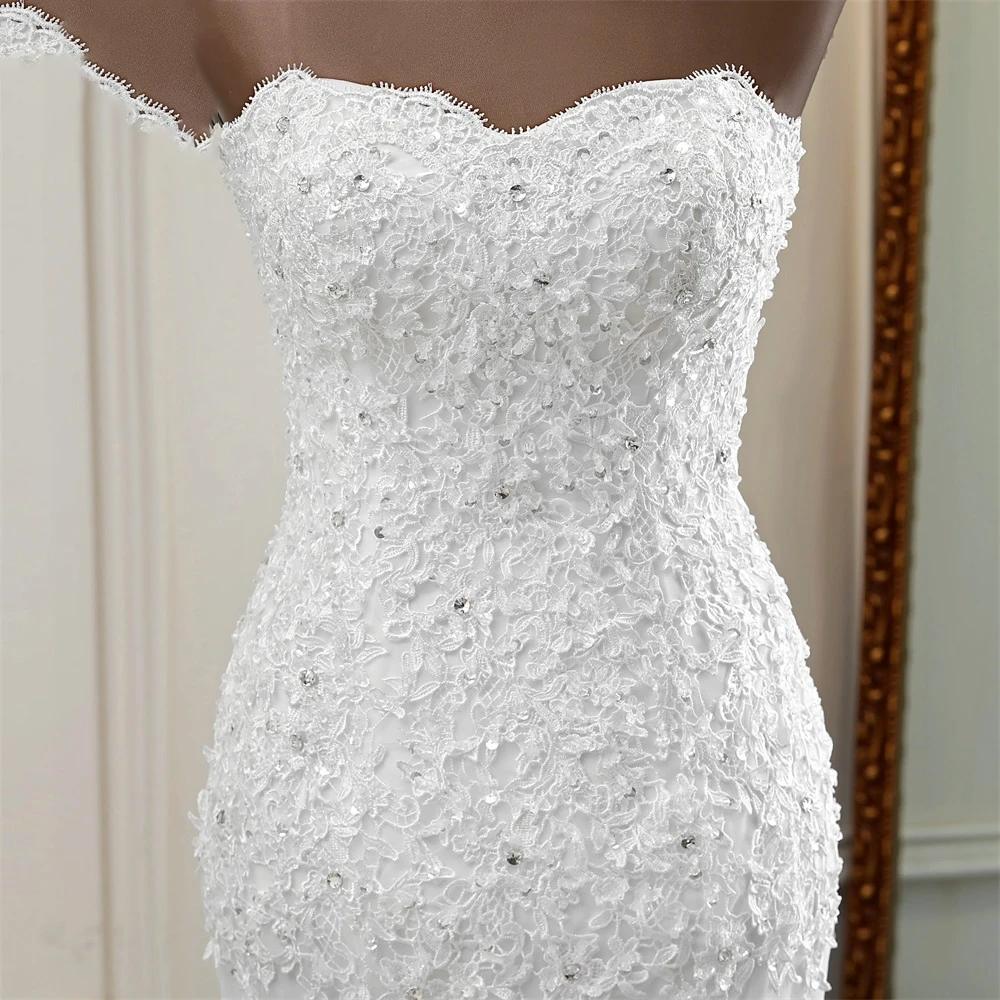 Detailed close-up of the sweetheart neckline on a strapless bridal gown featuring intricate embroidery and crystal embellishments.