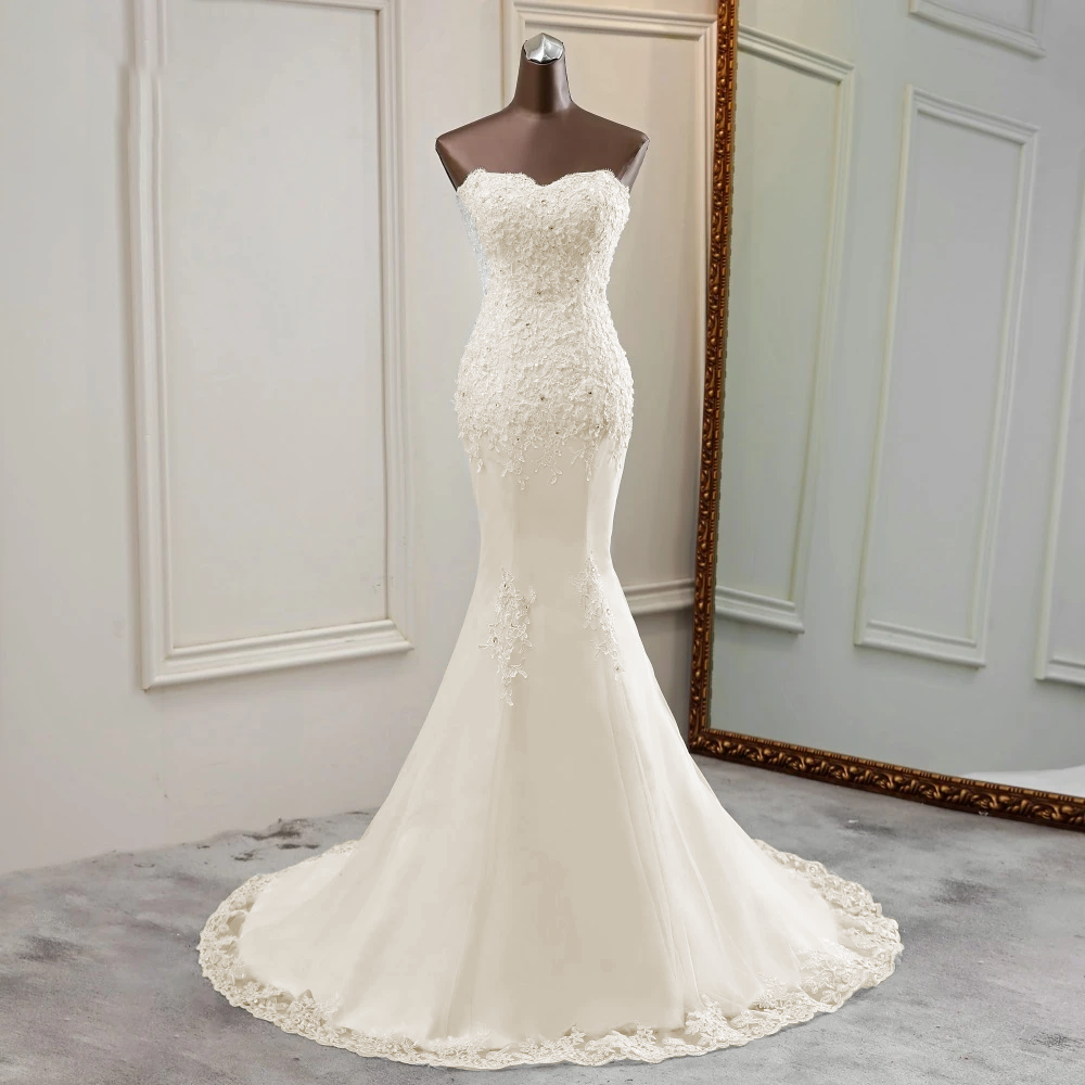 Elegant front view of a strapless mermaid wedding dress on a mannequin, showcasing the silhouette and beadwork.