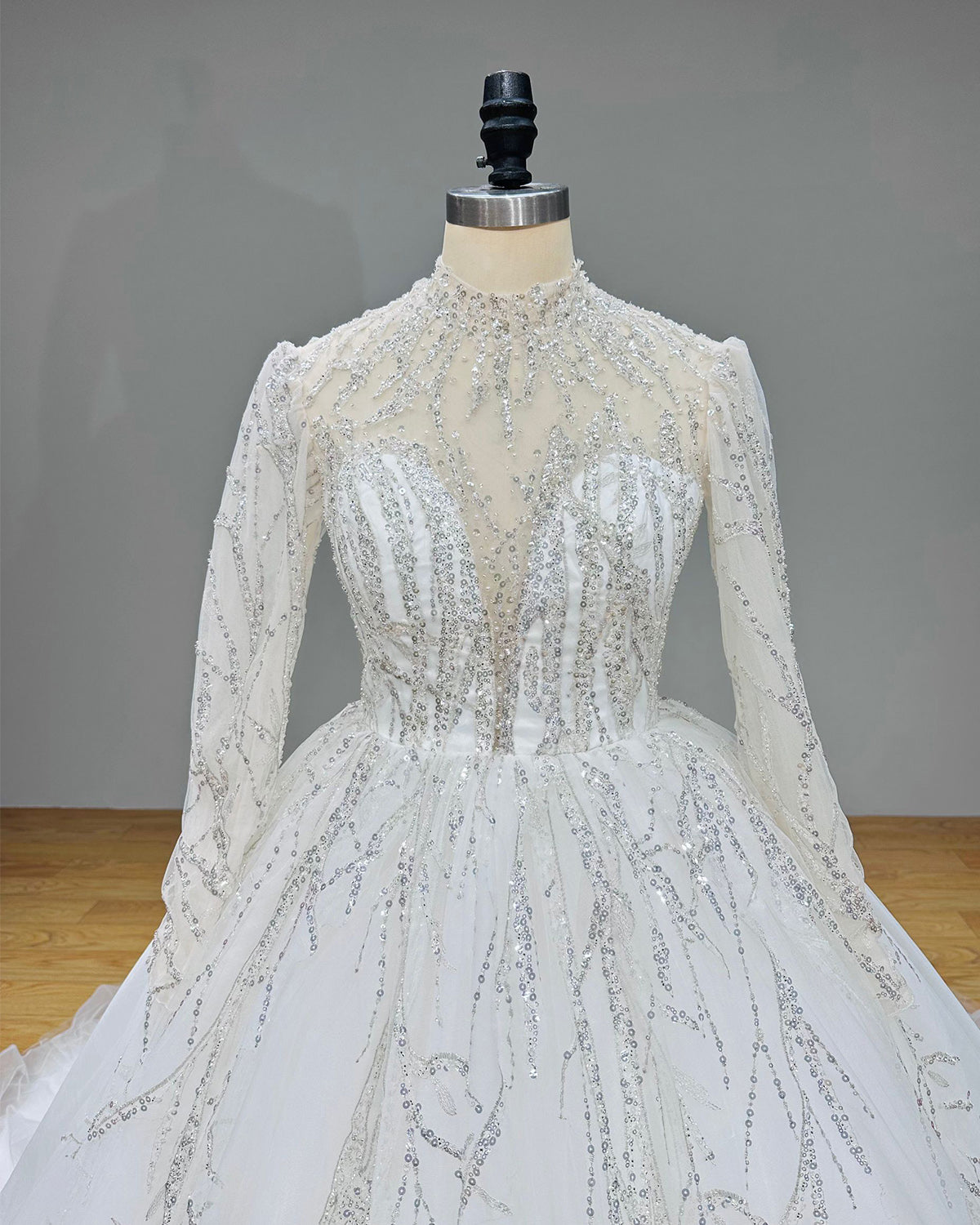 Close-up front view of a long sleeve luxury bridal bodice with an elegant sheer high neckline and inner sweetheart plunge.
