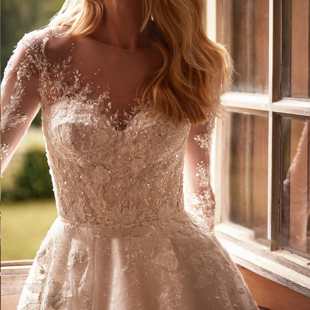 Detailed close-up of an intricate wedding dress bodice showcasing premium floral lace appliques, hand-beaded sequins, and a delicate shimmering waistband.