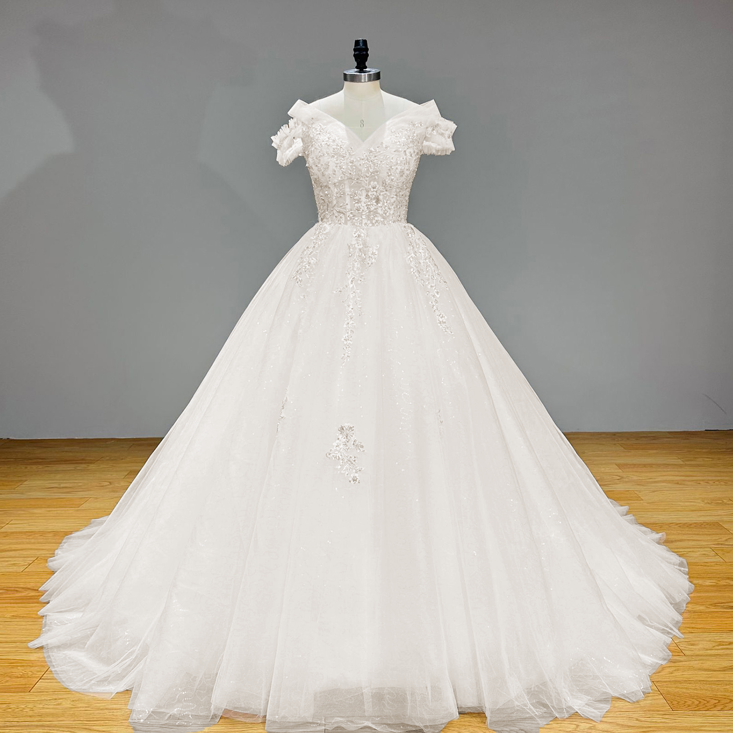 Studio front view of a majestic white sequin-beaded tulle princess wedding dress, or "vestido de novia style," with a voluminous ball gown silhouette.