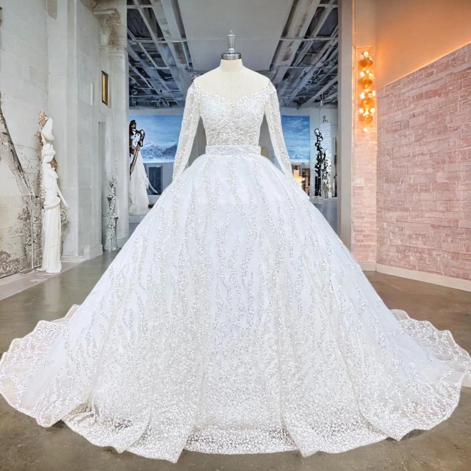 Front view of an elegant model wearing a white shiny beaded ball gown wedding dress with long sleeves and shimmering sequin patterns in a luxury bridal showroom.