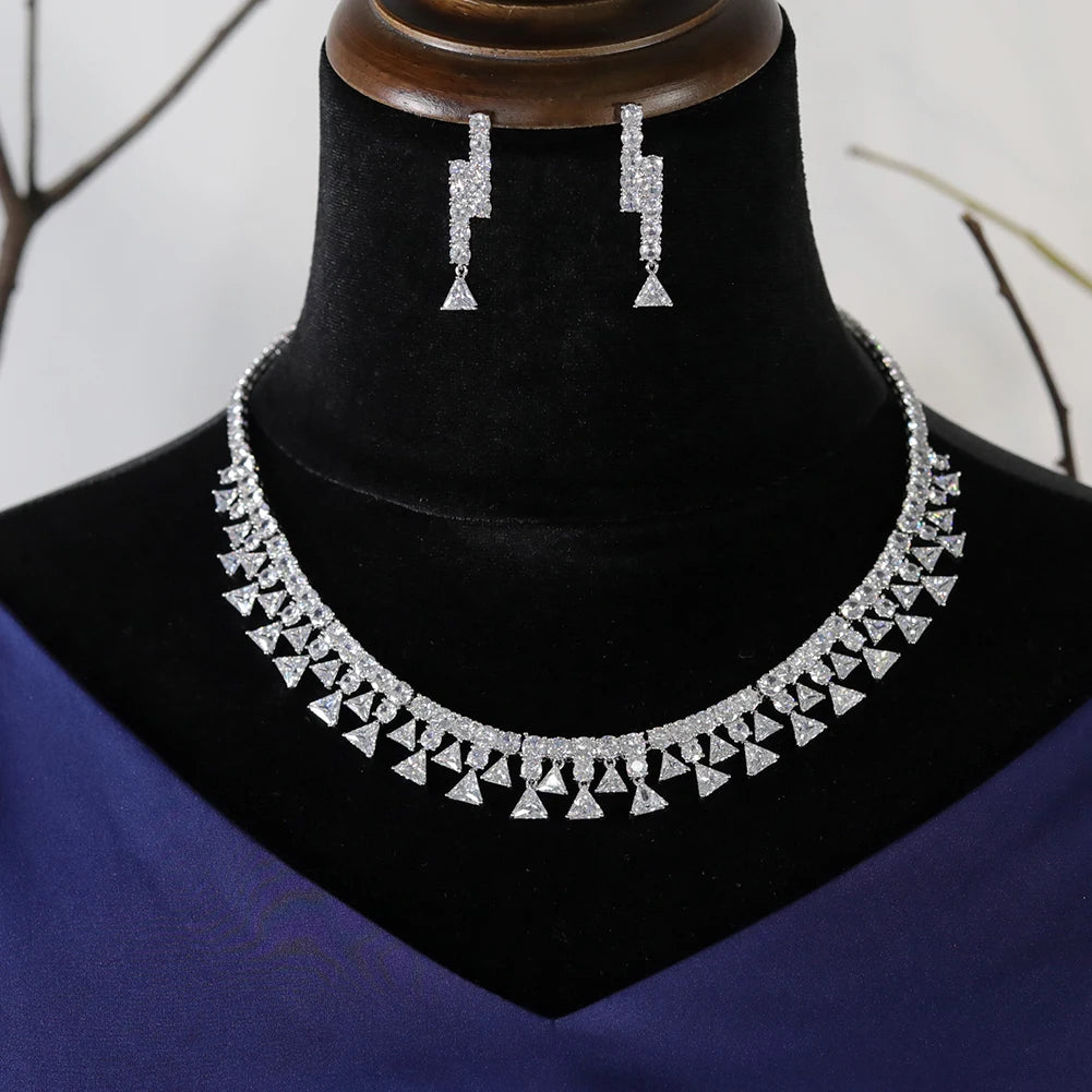 Front profile of a luxury cubic zirconia wedding jewelry 2pcs set with a cascading triangle fringe collar necklace displayed on a black velvet bust.