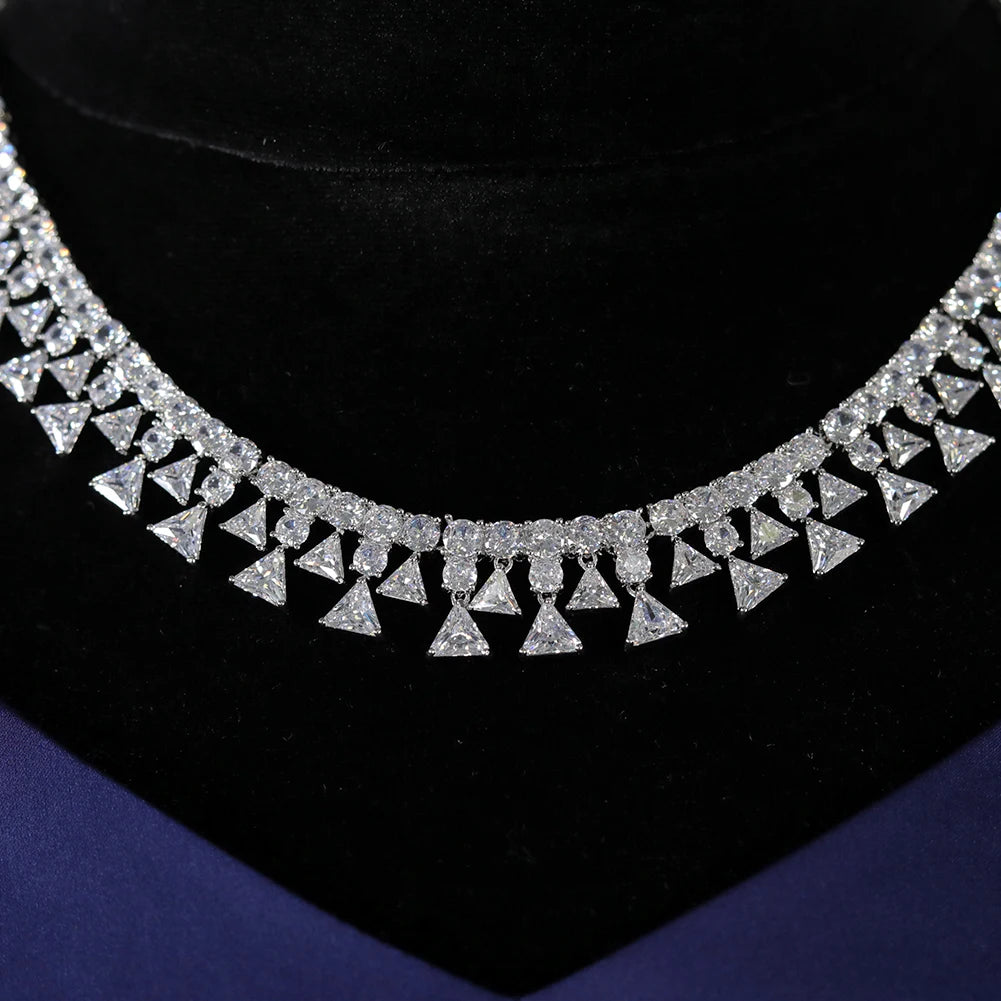 Macro view highlighting the intricate stone settings and alternating round and trillion-cut crystals on a shiny Nigerian bridal necklace.