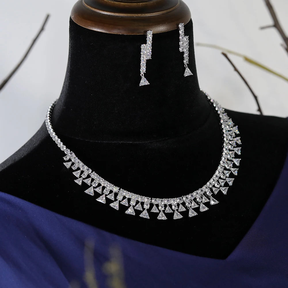 Side-angle view of the white gold plated cubic zirconia wedding party necklace and matching geometric dropdown earrings on a jewelry mount.