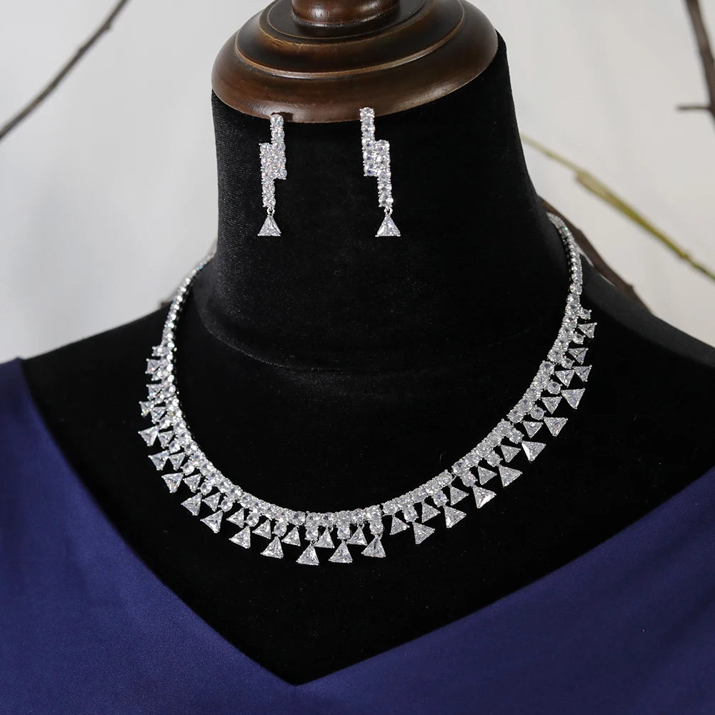 Complete 2pcs luxury zirconia bridal jewelry set featuring a detailed triangle drop fringe necklace and matching geometric earrings on a display bust.