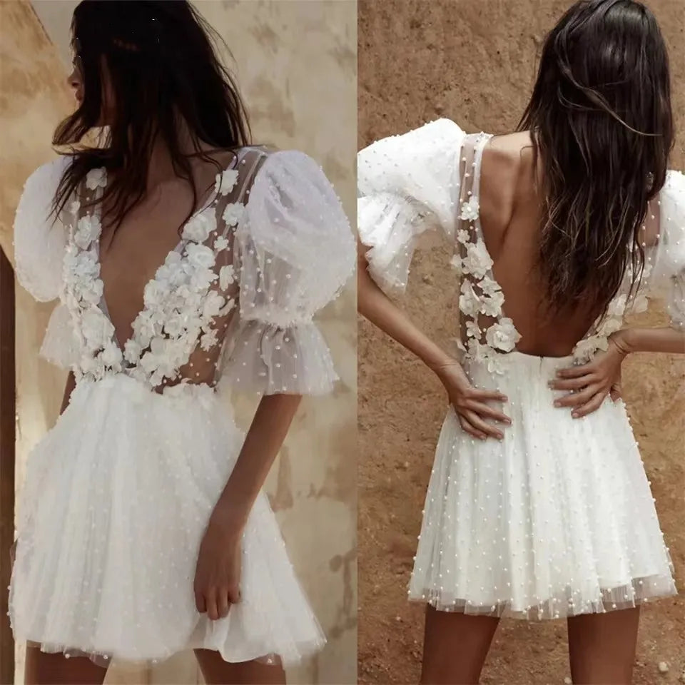 Double panel display showcasing the front plunging illusion neckline and the low open backless design of a short pearl-studded tulle wedding dress with floral details.