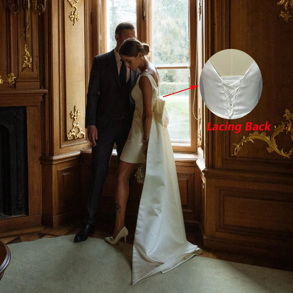Side profile of a short open-back satin wedding dress with an explanatory graphic highlight showcasing an alternative lace-up corset lacing back variation.