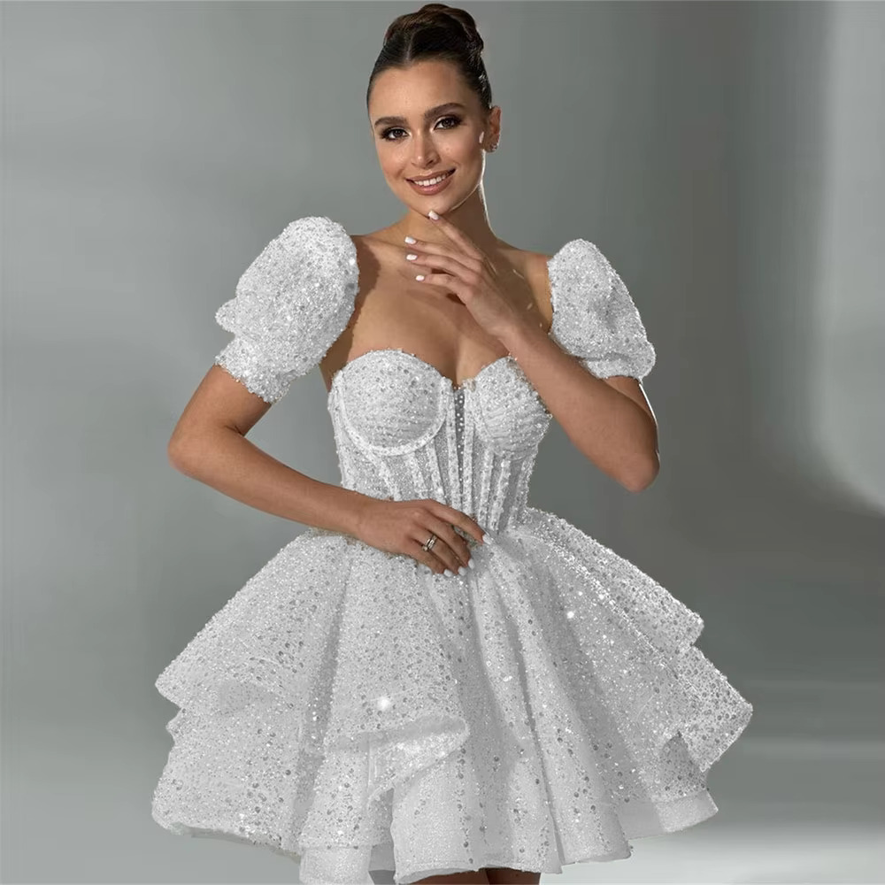 Stately pure white sequined short wedding dress with a boned sweetheart corset bodice and a tiered tulle mini skirt for a second reception look.