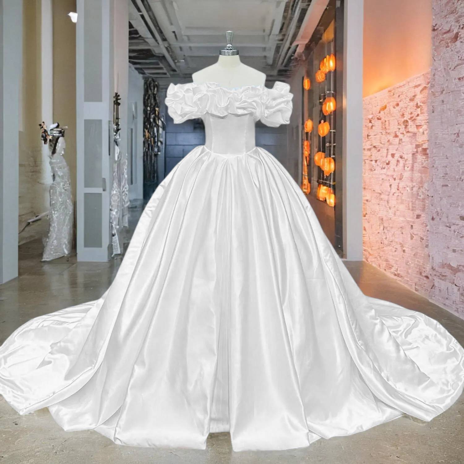 Grand display of a matte finish satin ball gown bridal gown with oversized ruffles, a structured bodice, and a full, pleated skirt.