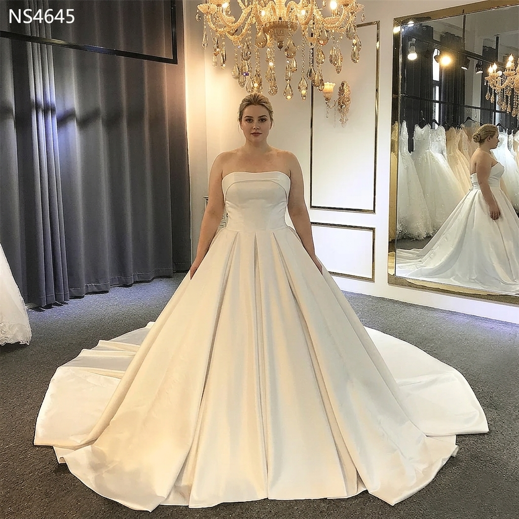 Full-length view of a luxury mermaid bridal gown with a 2-in-1 design, showcasing a fitted lace bodice and a grand detachable train in a professional showroom setting.