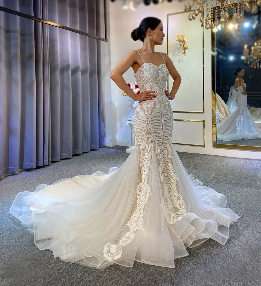 A plus-size model showcasing the elegant high-quality slim lace bridal gown with a flattering fit-and-flare silhouette and delicate floral embroidery.