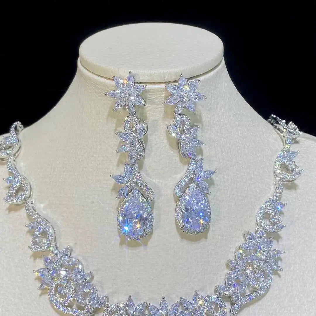 Detailed view of elegant zircon crystal floral dropdown statement earrings from a wedding jewelry set.