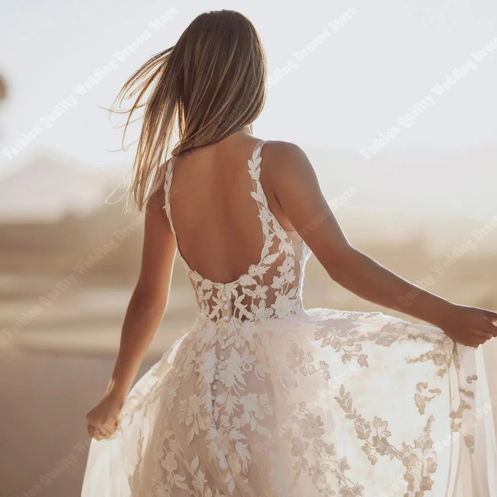 A detailed rear view of a sleeveless A-line bridal gown showcasing a lace-up corset back and a flowing, shining tulle skirt.