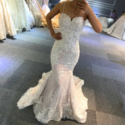 Front view of an elegant strap lace mermaid wedding dress with a patterned floral design and sweetheart neckline, perfect for a beach bridal look.