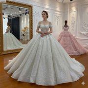 Full-length view of an elegant off-the-shoulder strap wedding dress with a sparkling ball gown skirt and 100cm train.