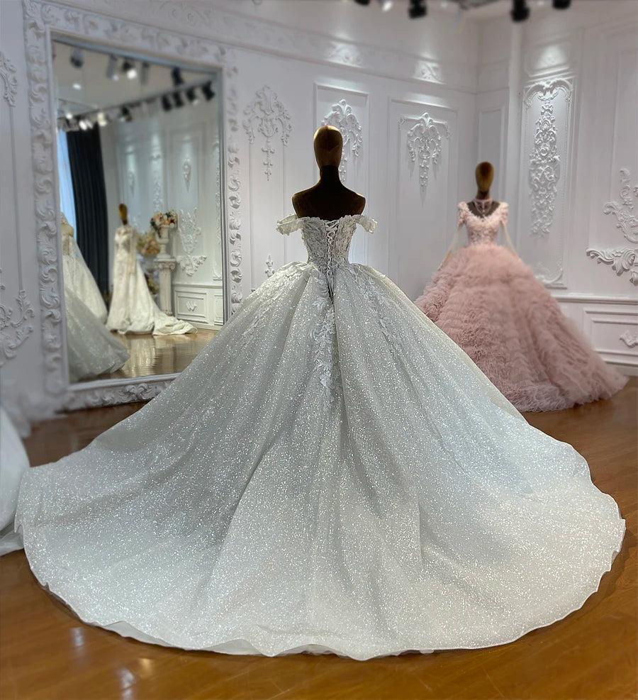 Back view of a luxury bridal dress showcasing a structured lace-up corset and a wide 100cm sparkling train.