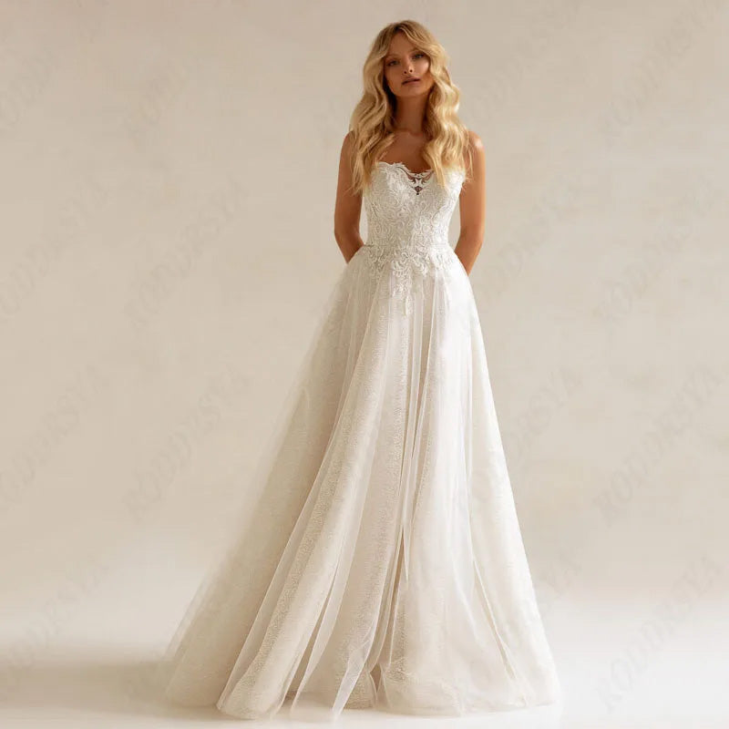 A mannequin displaying an A-line wedding dress featuring intricate lace appliques and a delicate illusion neckline.