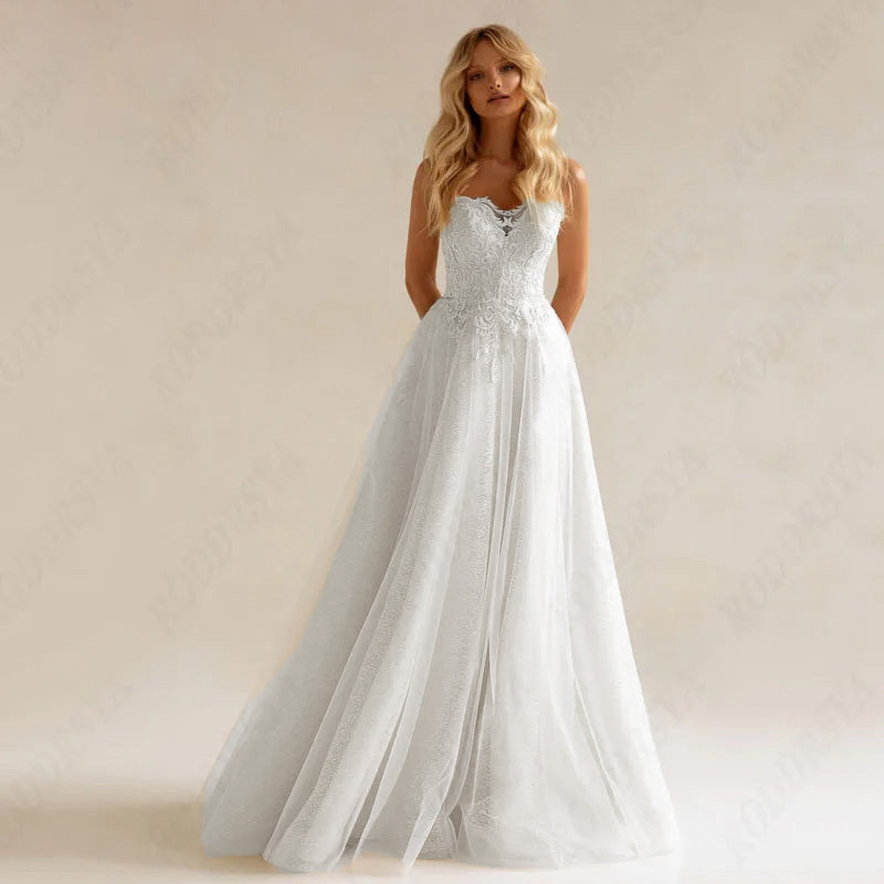 An elegant bride wearing a full-sleeve A-line wedding dress with a long train and detailed beaded appliques.