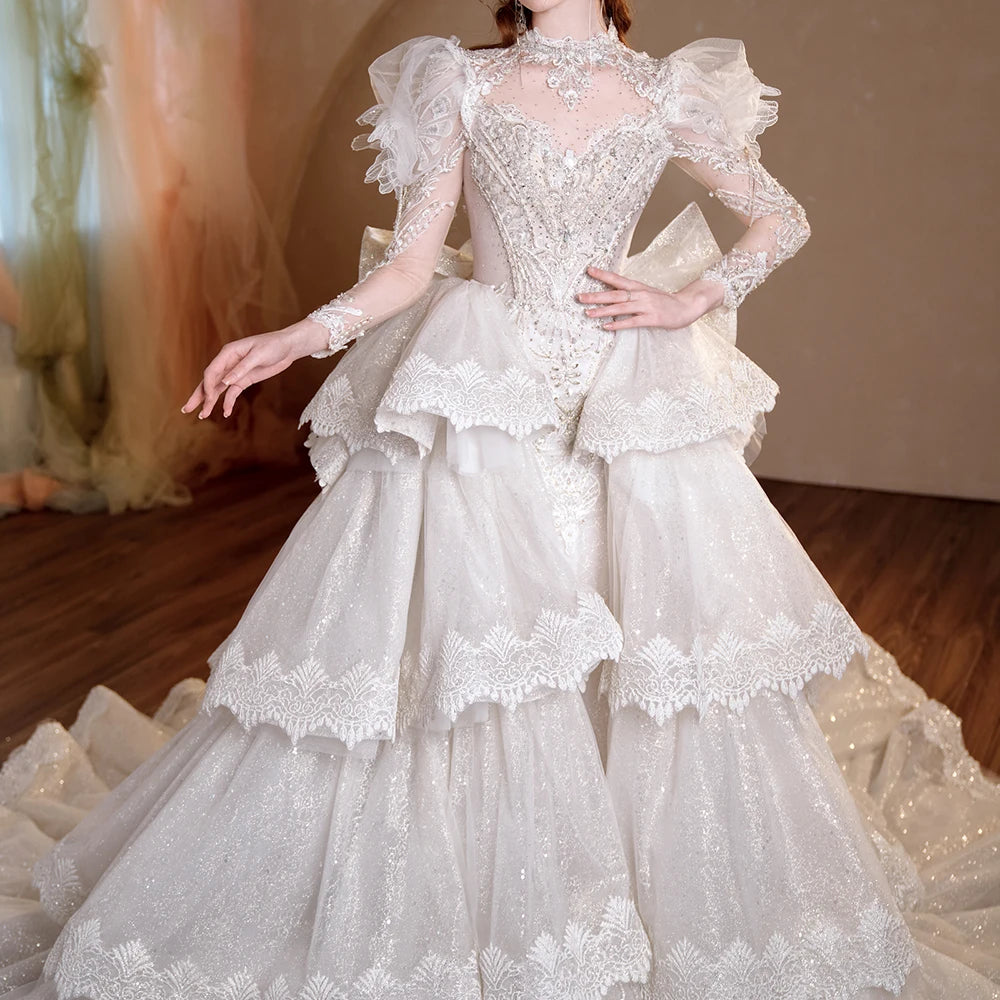 Detailed rear view of the bridal gown on a mannequin, emphasizing the elegant lace-up corset back and a dramatic tiered statement bow at the waist.