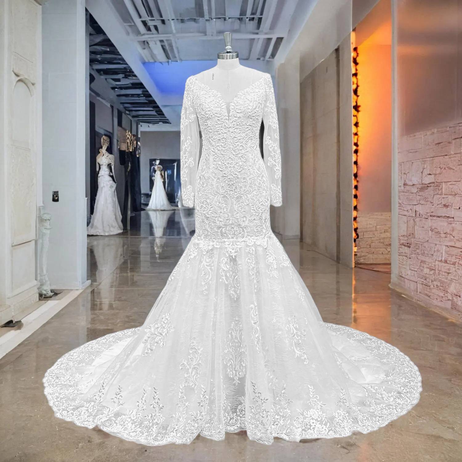 Front full-length view of a sweetheart lace mermaid wedding dress with pearls and a detachable skirt extension in a professional bridal boutique.