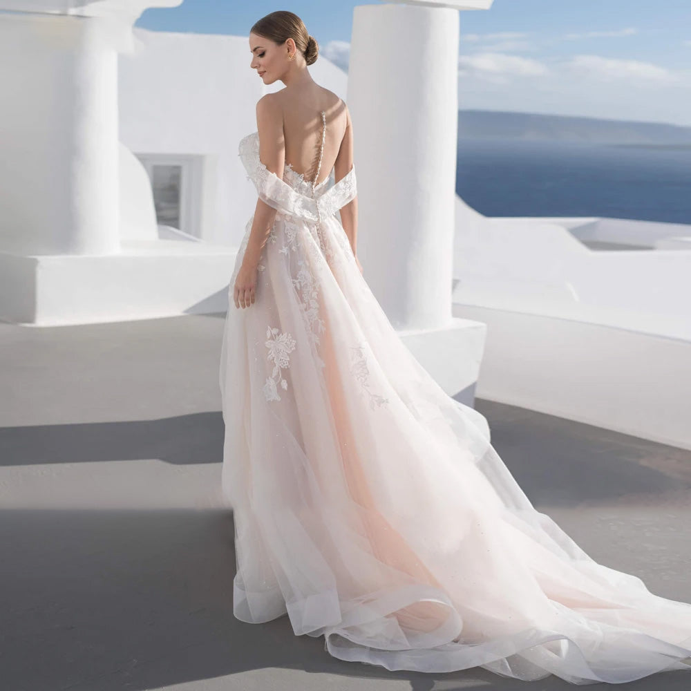 Back view of a bride wearing a sweetheart lace A-line vintage wedding dress with button detailing along the back and a flowing court train.