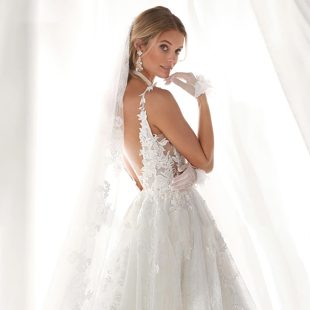 A-line wedding dress with a romantic lace bodice, sweetheart neckline, and long flowing skirt.