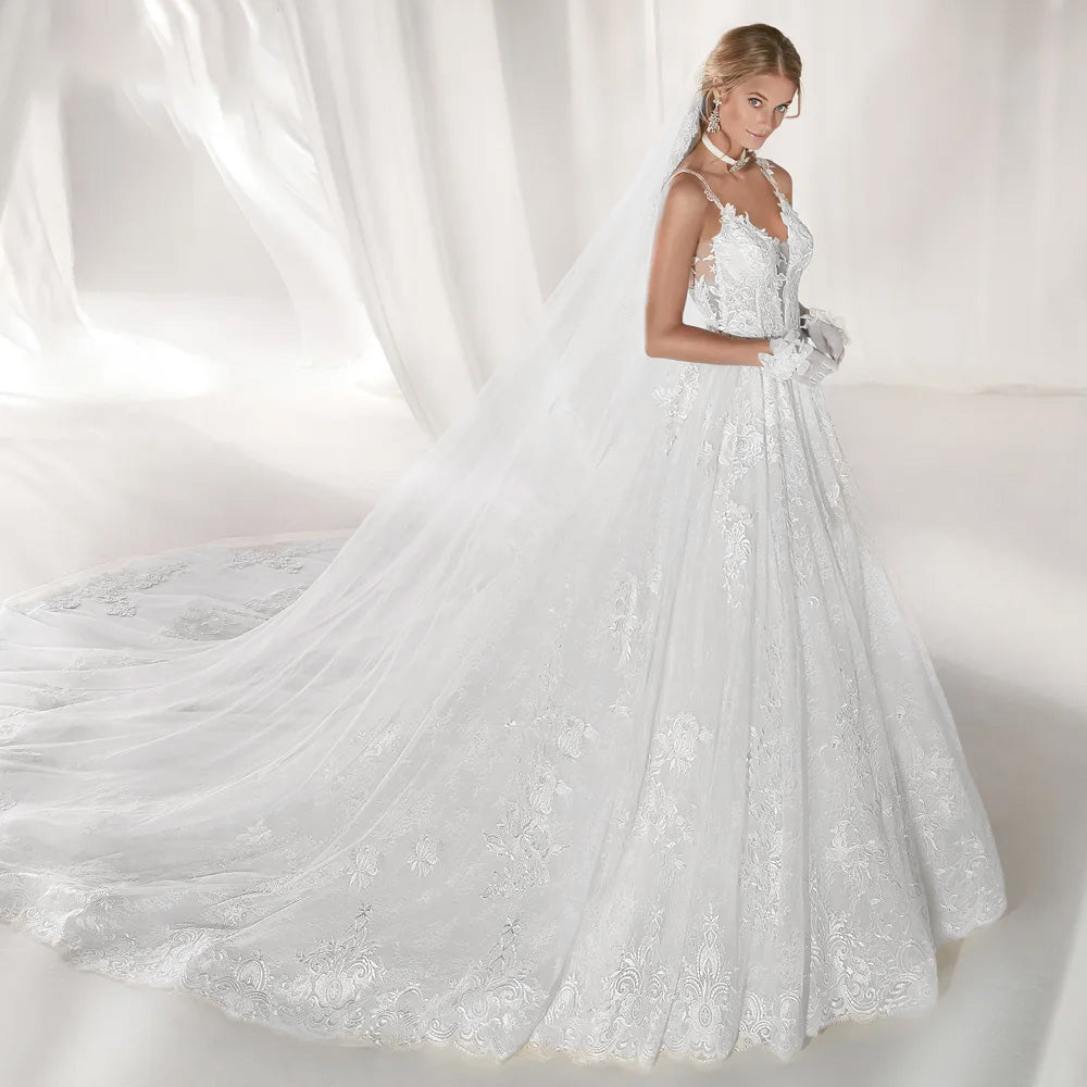 Full-length front view of an elegant lace A-line wedding gown with a sweetheart neckline and dramatic train.