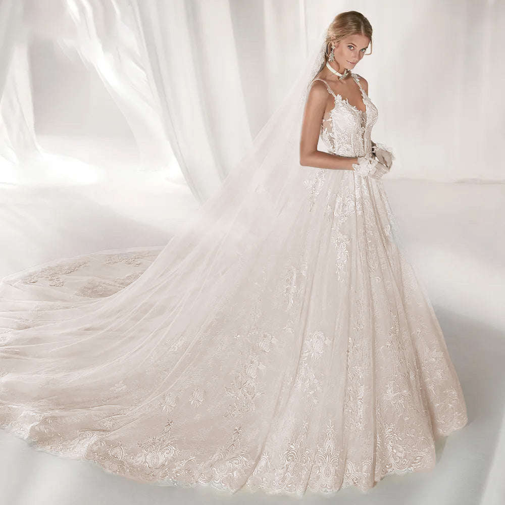 A-line wedding dress featuring a lace bodice, sweetheart neckline, and a sweeping train for a romantic loo