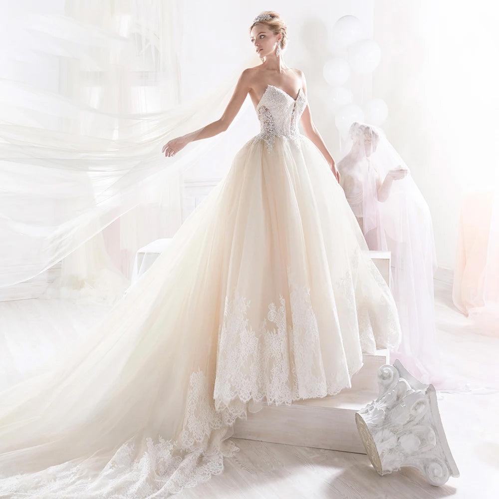 Elegant sweetheart neck A-line wedding dress featuring intricate beaded appliques and a flowing court train.