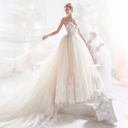 Elegant sweetheart neck A-line wedding dress featuring intricate beaded appliques and a flowing court train.