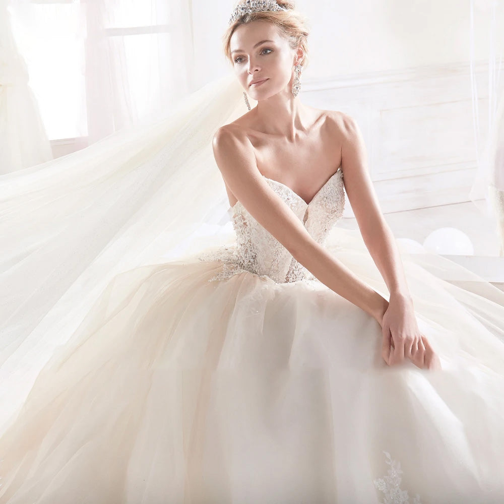 Close-up of a vintage-style bride in a sweetheart neck wedding dress with detailed beaded embroidery on the bodice.