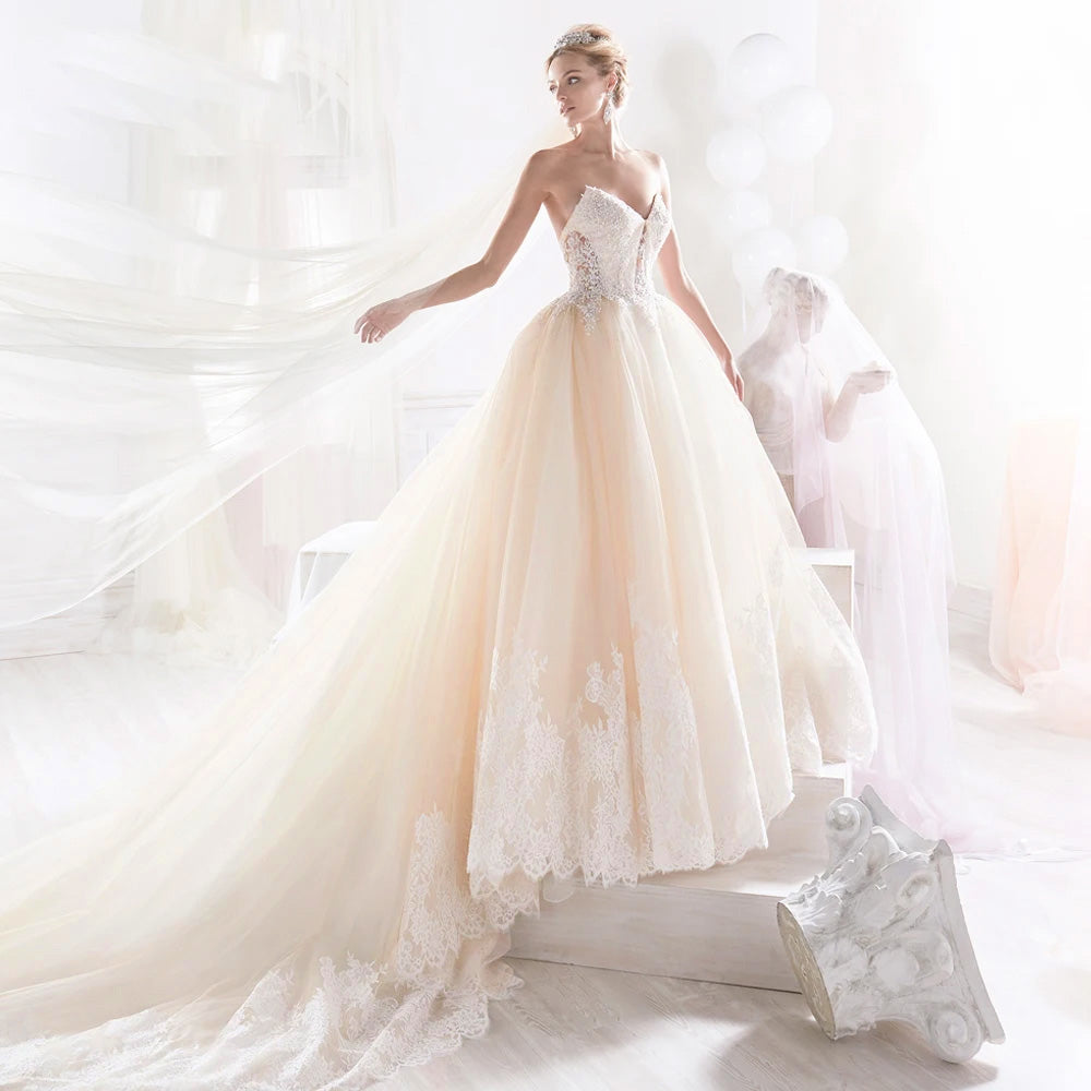 Side-profile view of a romantic A-line bridal gown featuring a sweetheart neckline and elegant beaded appliques.