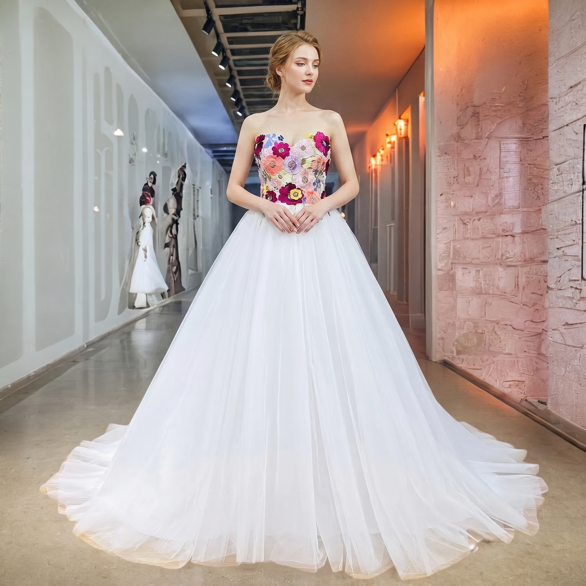 Elegant model posing in a white ball gown wedding dress with a deep sweetheart neckline and a vibrant, colorful floral beaded sequin bodice in a luxury bridal showroom.
