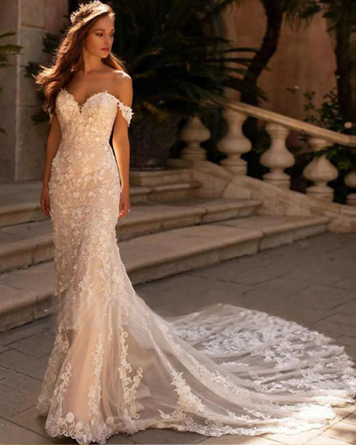 Detailed rear view of a mermaid wedding dress bodice on a mannequin, featuring a sheer lace illusion back with an elegant row of bridal buttons.