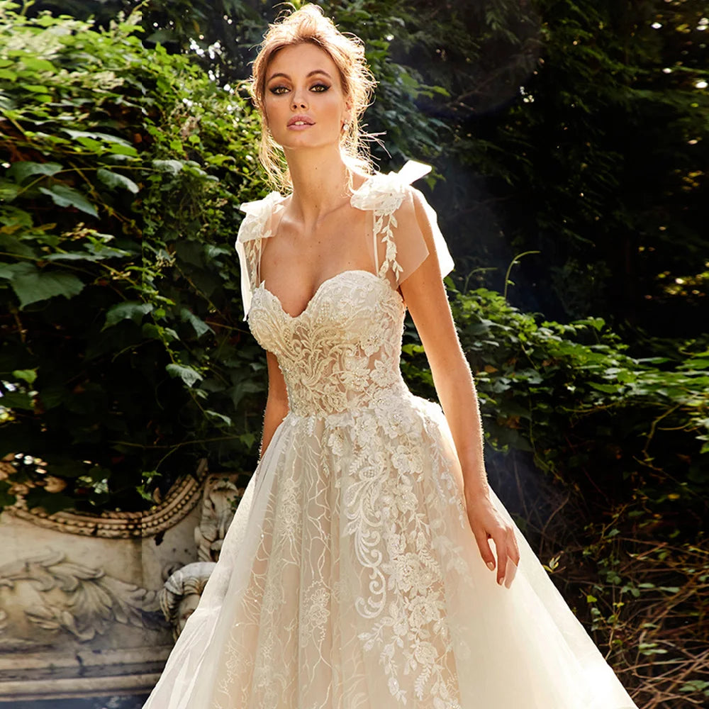 Front profile of a vintage-inspired A-line wedding dress featuring intricate beaded bodice embroidery and a sweetheart neck.
