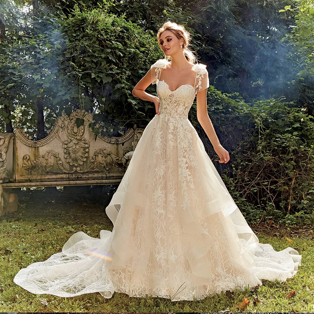 Full-length view of a luxury A-line bridal gown with a soft sweetheart neckline and detailed lace overlay.
