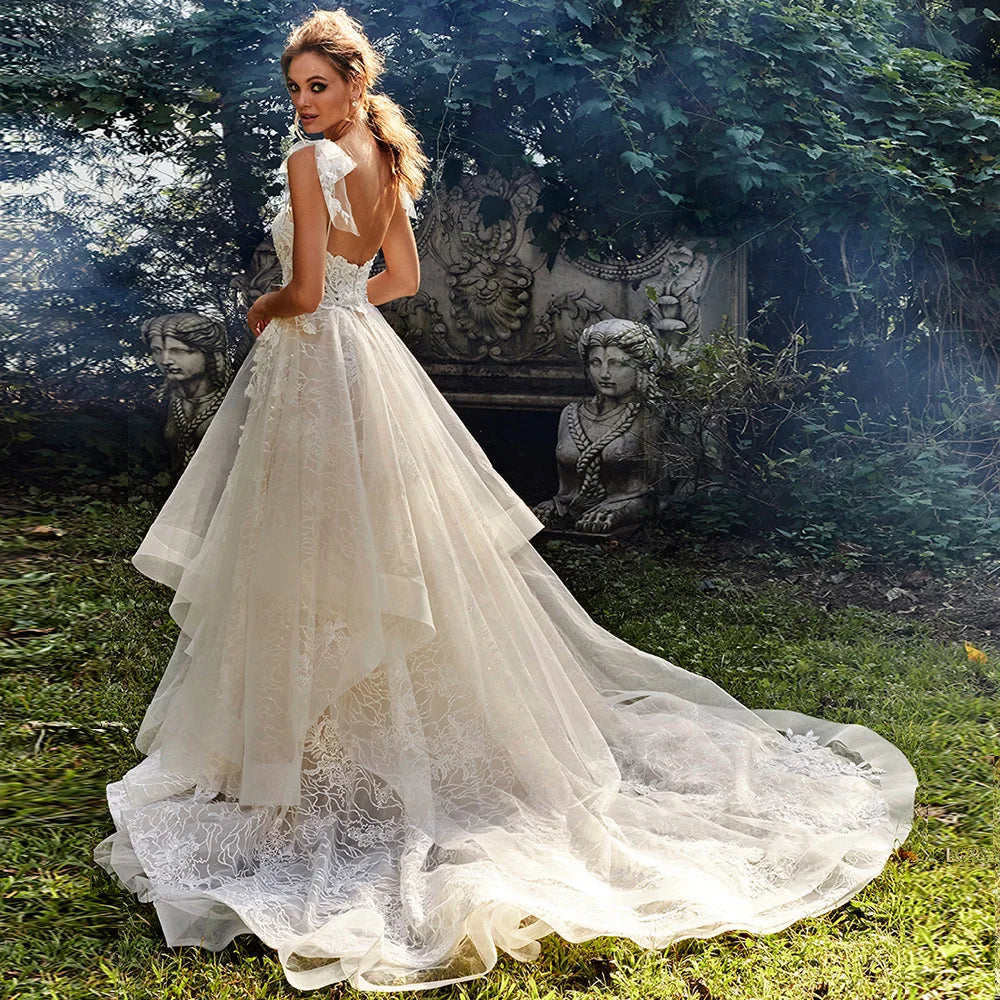 Elegant A-line wedding dress with intricate floral appliques, captured in a lush garden setting.