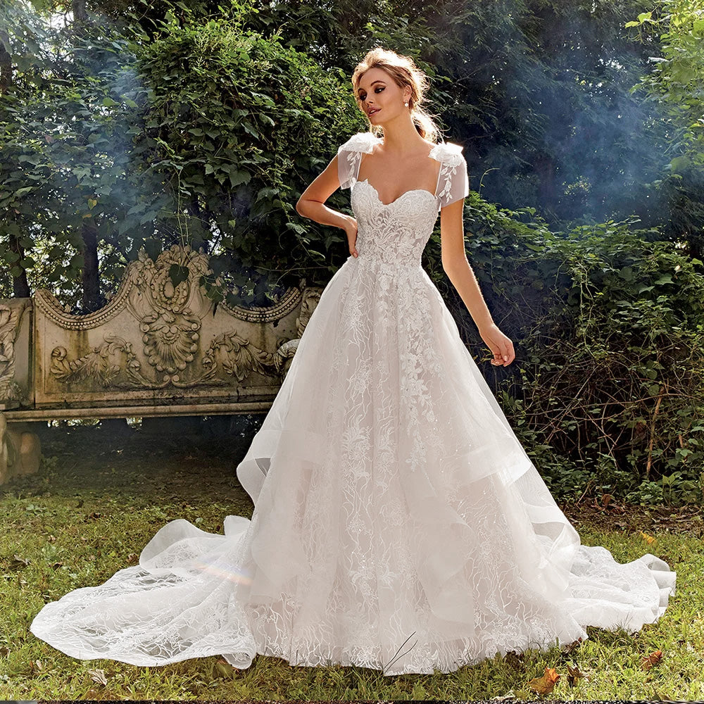Close-up of a sweetheart neck wedding dress bodice with detailed beaded floral appliques.