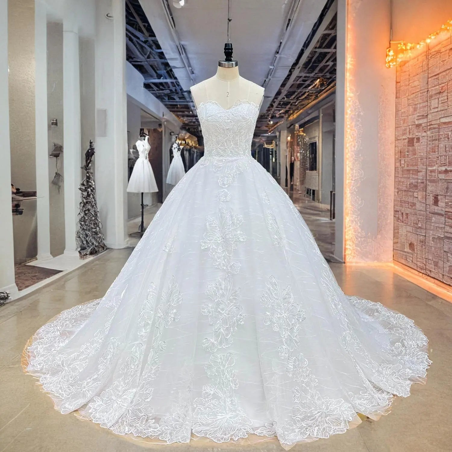 Full front view of a sparkling transparent sequined appliques ball gown wedding dress on a mannequin in a studio hallway, highlighting the classic bodice and shimmering tulle.