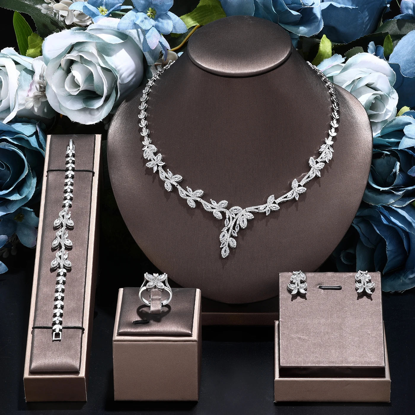 Front profile view of the complete 4PCS bridal party jewelry set, highlighting the asymmetric marquise crystal branch arrangement on a dark display bust.