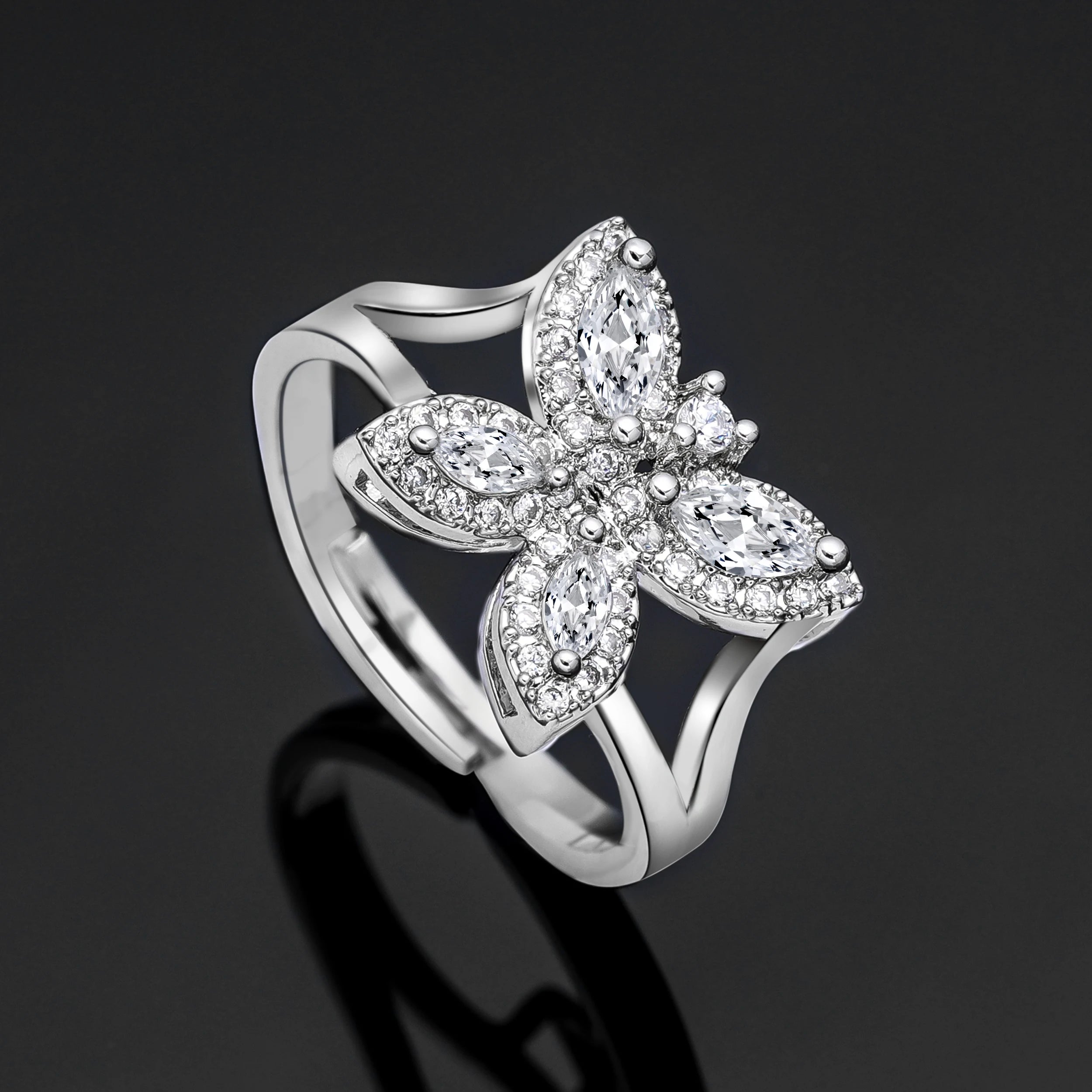 High-resolution product shot of a silver cubic zirconia butterfly statement ring from a luxury bridal party accessory collection.