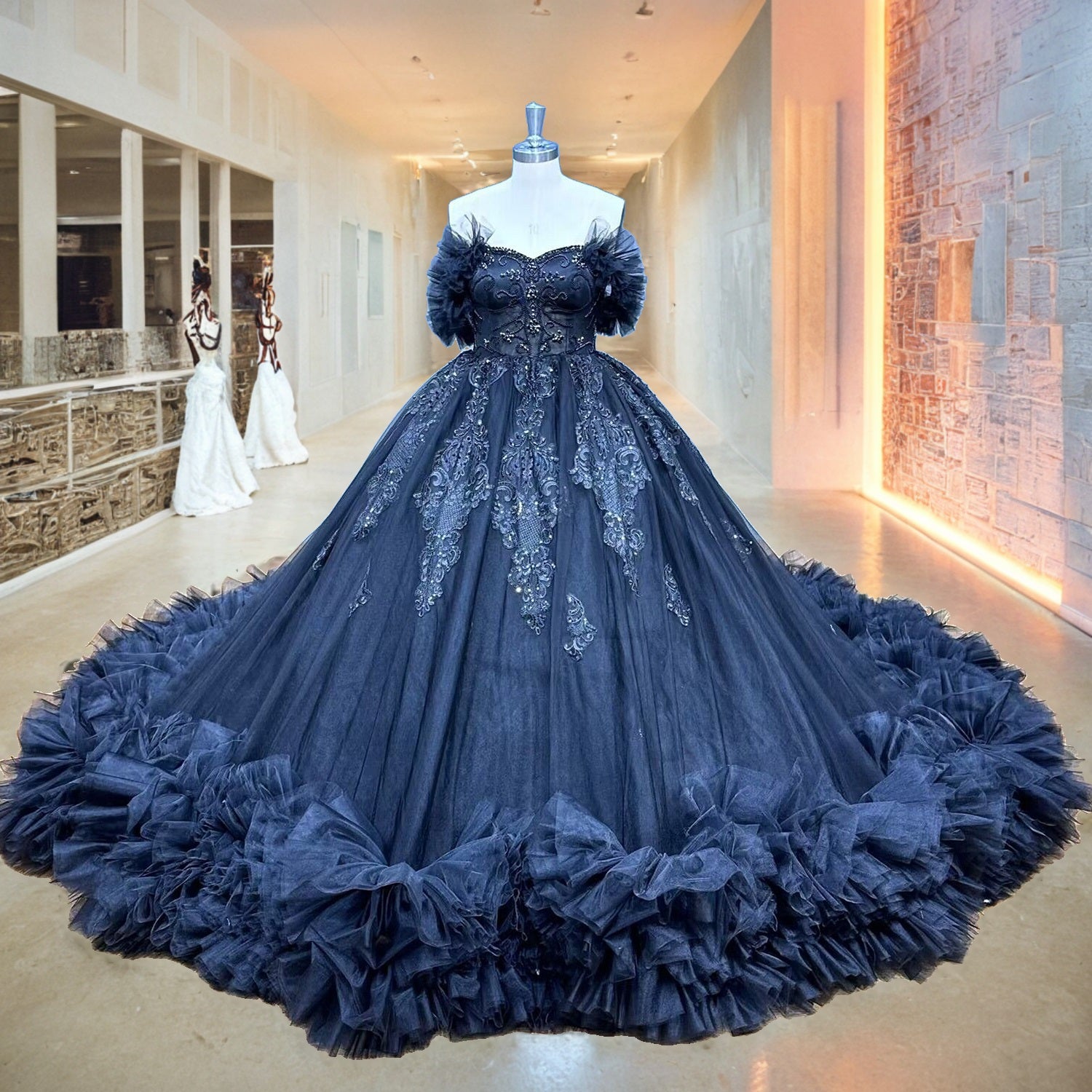 Classic tulle ball gown wedding dress with an off-the-shoulder sweetheart neckline displayed on a mannequin in a modern bridal boutique hallway.
