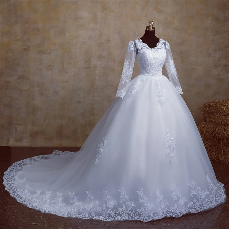Elegant plus size wedding gown with a V-neck and full-length sleeves, showcased on a dress form.
