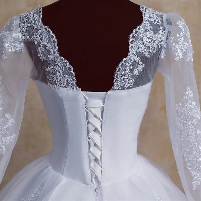 Detailed close-up of the back of a wedding dress, highlighting the intricate lace bodice and secure lace-up corset back.