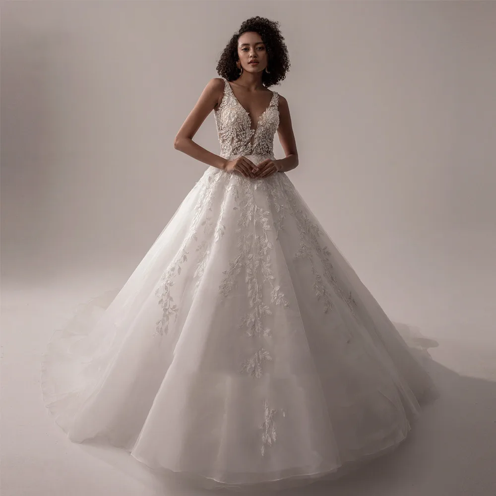 Elegant sleeveless A-line bridal gown with a deep V-neck and delicate lace floral embroidery.