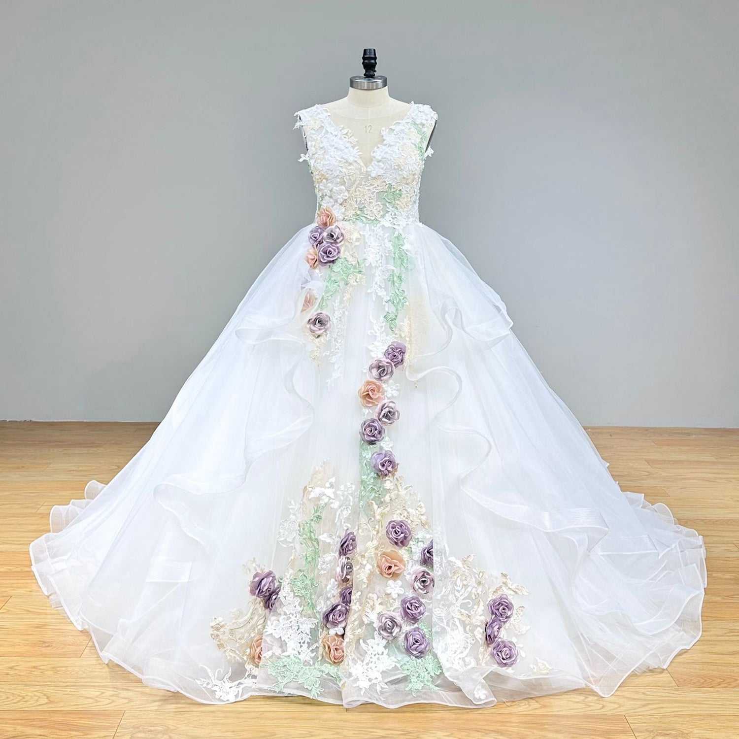 Wide front studio view of a luxury off-shoulder vintage ball gown wedding dress on a mannequin, perfectly displaying the regal silhouette and classic bridal elegance.