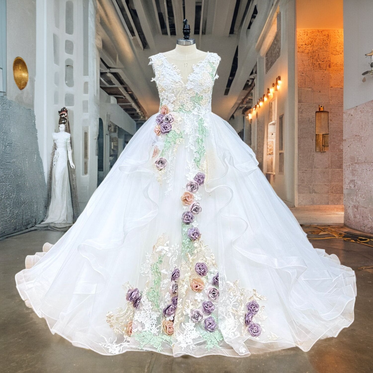 Full front view of a classic vintage ball gown wedding dress on a mannequin in a studio hallway, highlighting the elegant off-shoulder neckline and voluminous skirt.